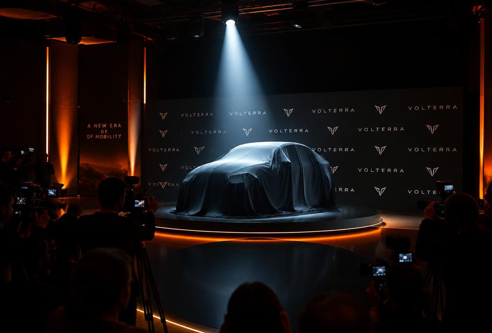 Product launch stage with dramatic spotlight and media wall